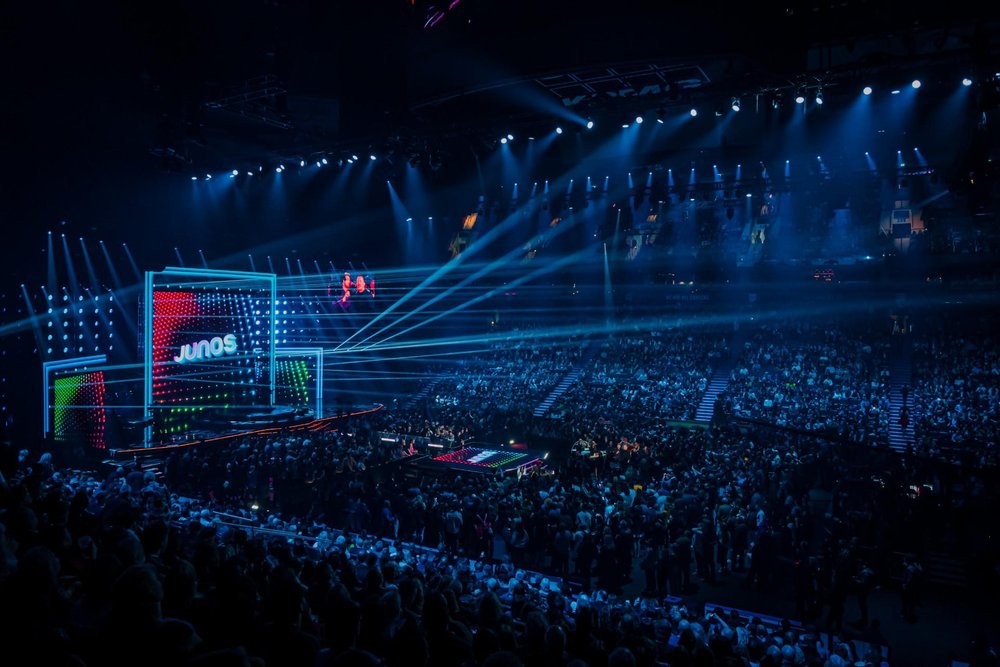 JUNO stage lit up for awards show with a full arena of fans.