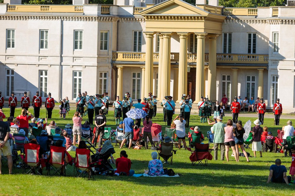 People gathered in lawn chairs in front of Dundurn National Historic Site on Canada Day.