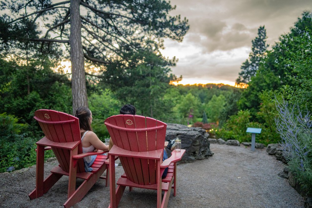 A couple sitting in chairs in RBG Rock Garden.