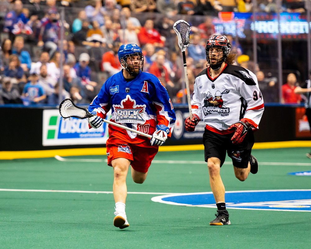 Toronto Rock player running with stick into the play action.