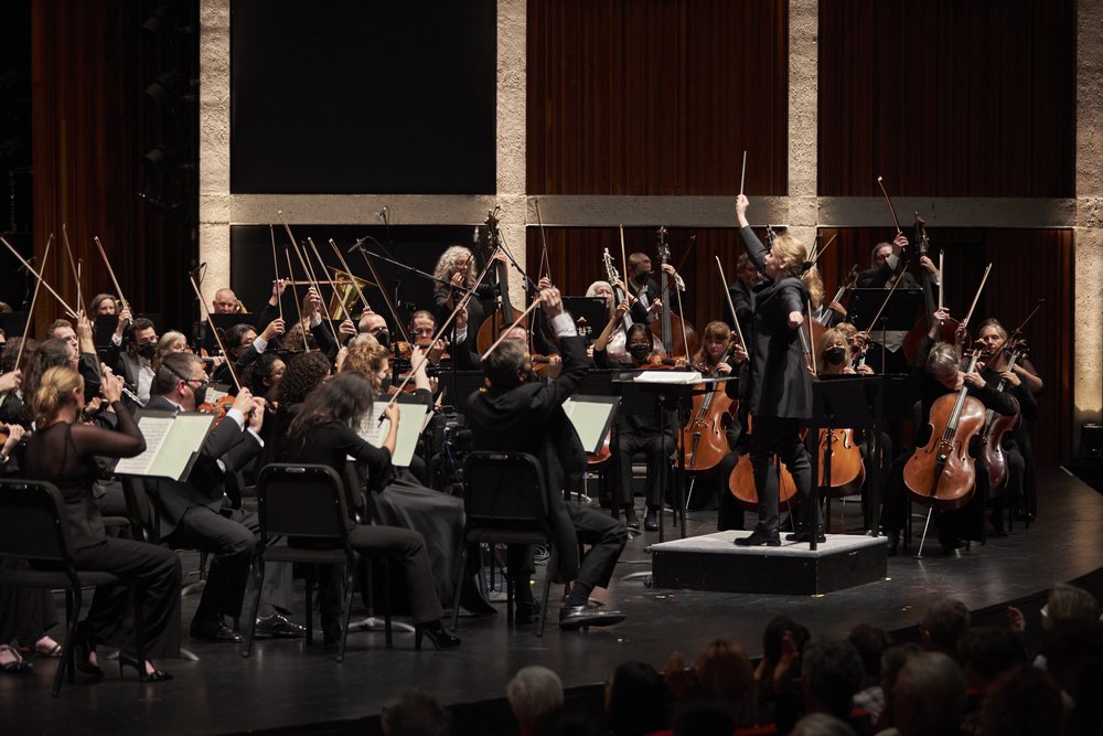 Conductor on stage with HPO.