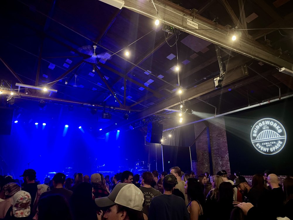 A full audience at Bridgeworks with the stage lights on before a show.