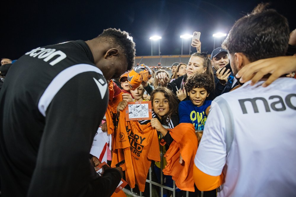 Forge FC player meeting with fans after match.