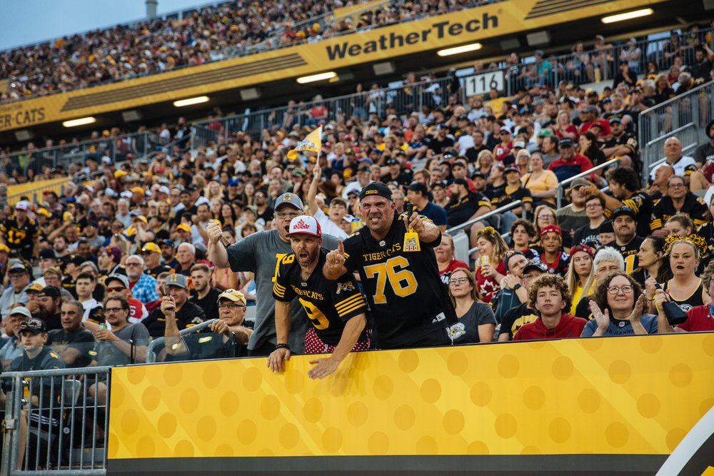Ti-Cats fans cheering in the stands at Tim Horton's Field.