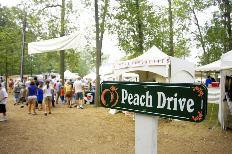Peach festival crowd and sign.