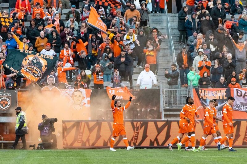 Forge FC players cheering on the field.