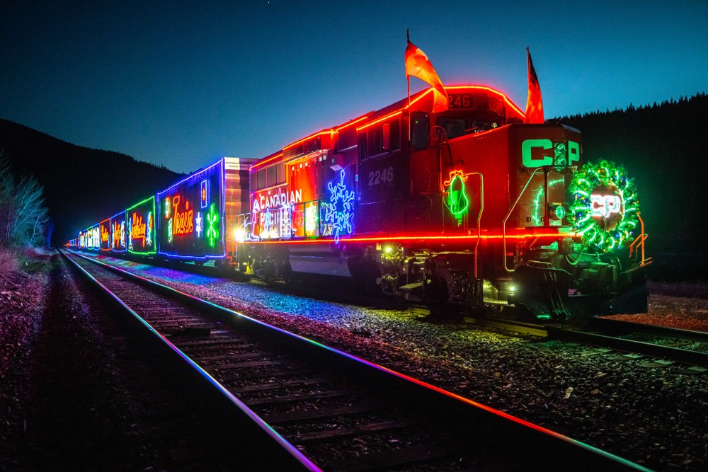 CP Holiday Train on route with festive holiday lights.