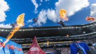 Nirto Circus athletes completing jumps in the air on motor bikes.