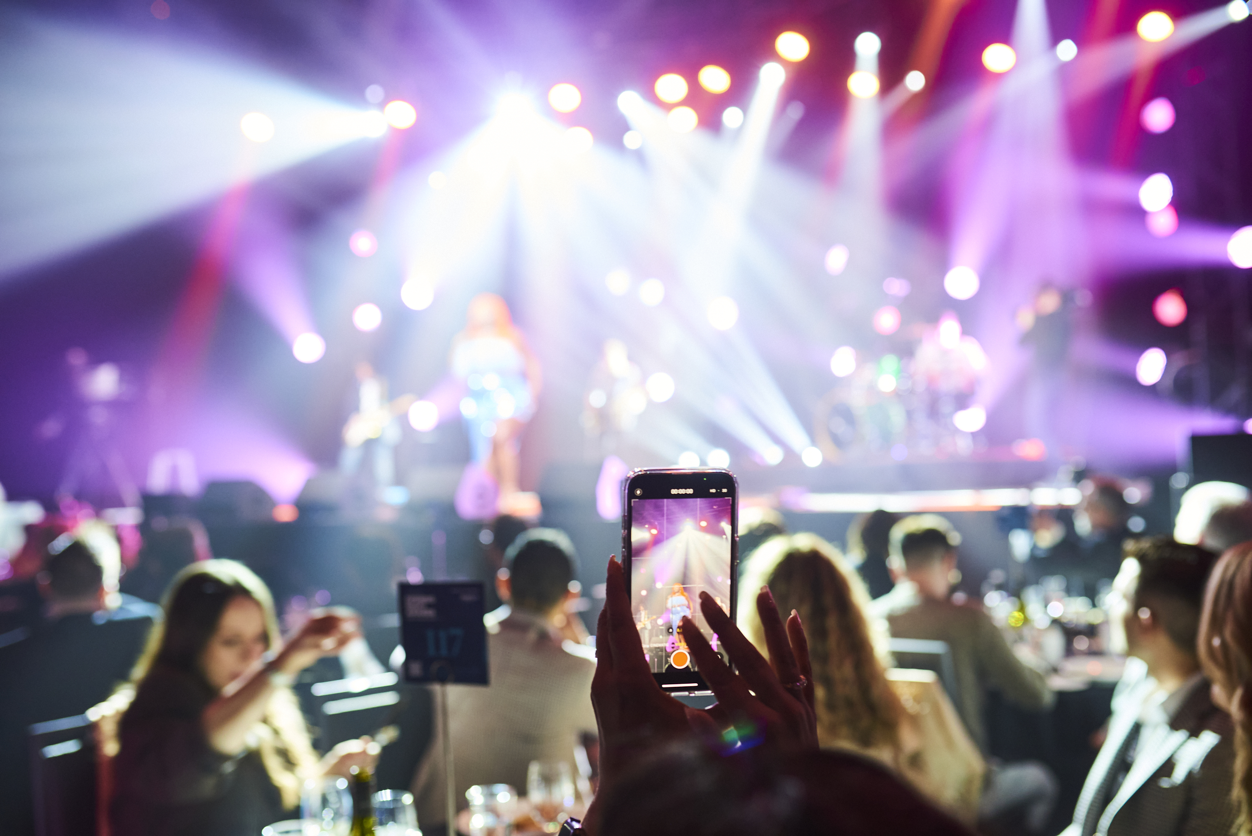 A phone in the crowd - taking a picture of the performers on stage