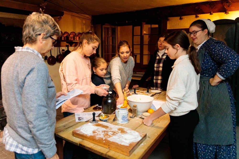 People cooking in the historic kitchen at Dundurn Castle.