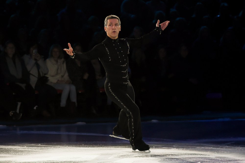 Male figure skater on centre ice during a performance.