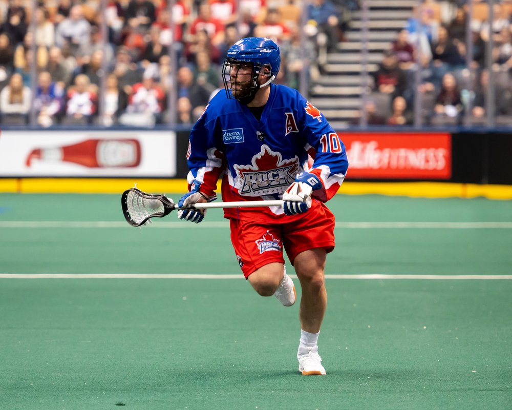Toronto Rock player running with lacrosse stick.