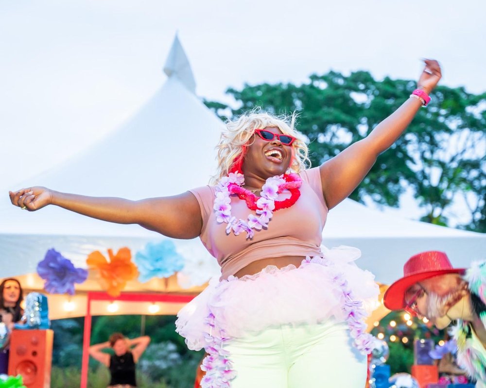 Pride Summer Party at RBG with arms wide open enjoying themselves.