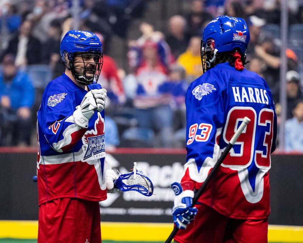 Two Rock players high fiving on the field.