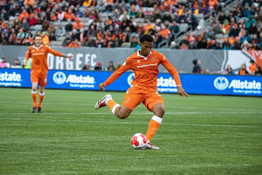 Forge FC player mid-kick on the field.