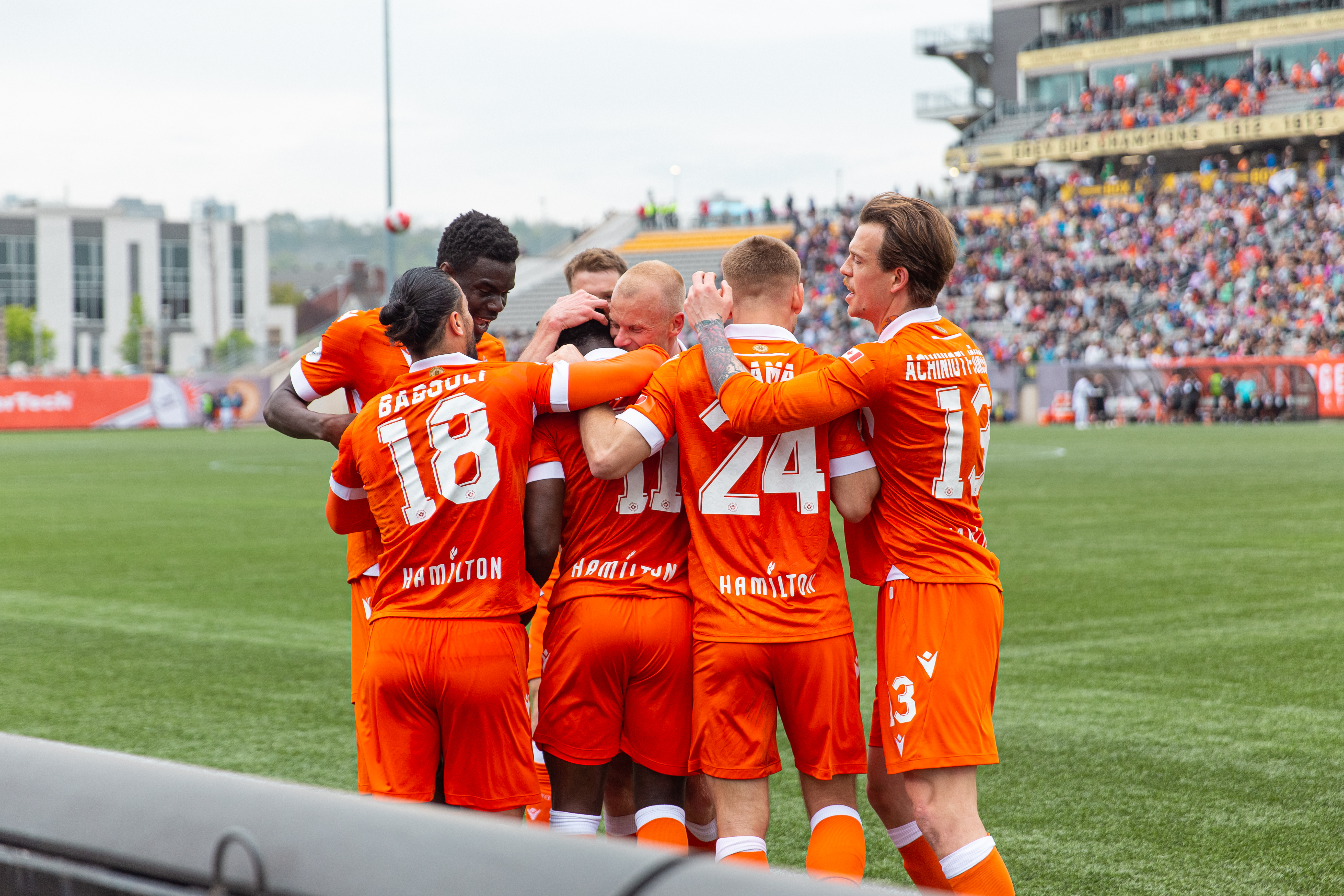 Forge FC players celebrating on field.