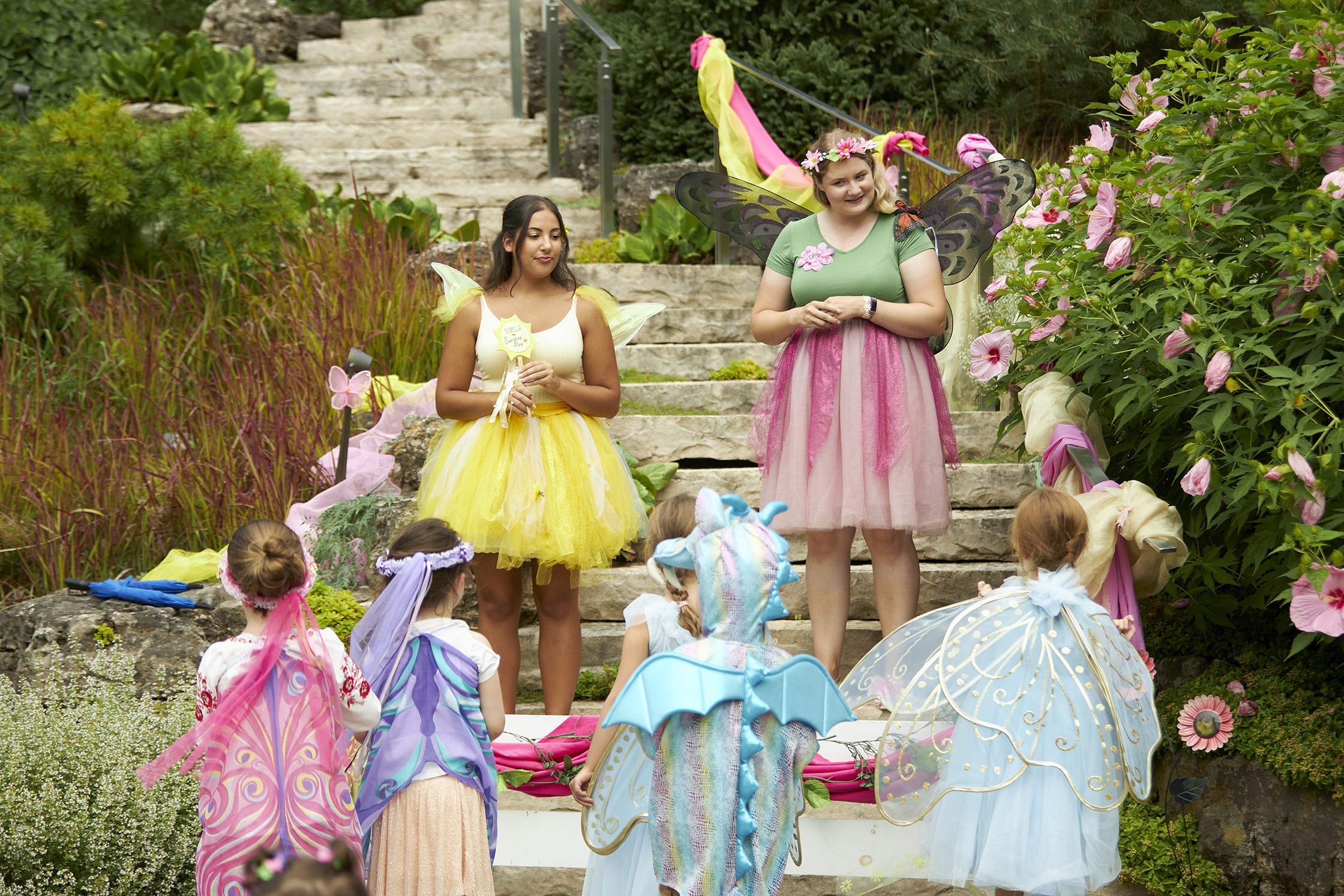 Children in fairy costumes gathered around in RBG Rock Garden.